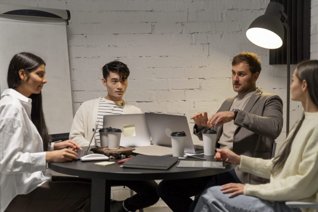 Team of digital strategists and marketing experts discussing project strategy in modern office,
