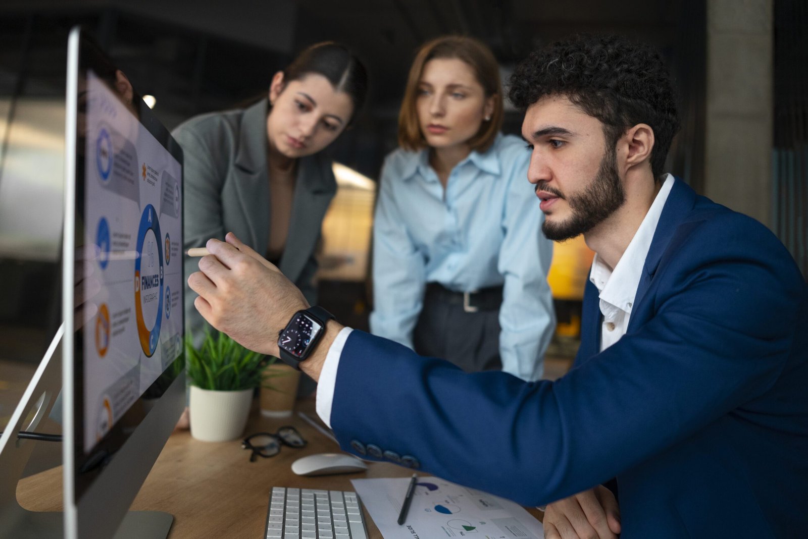 Financial analysts and business professionals reviewing data and strategy on computer