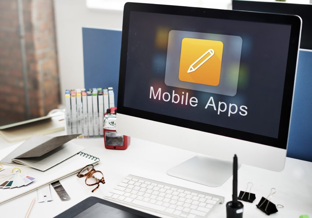 Mobile app development concept on desktop screen with design tools and creative setup