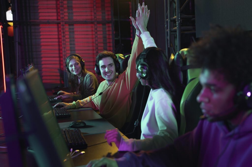 young professionals collaborating and celebrating success while gaming together