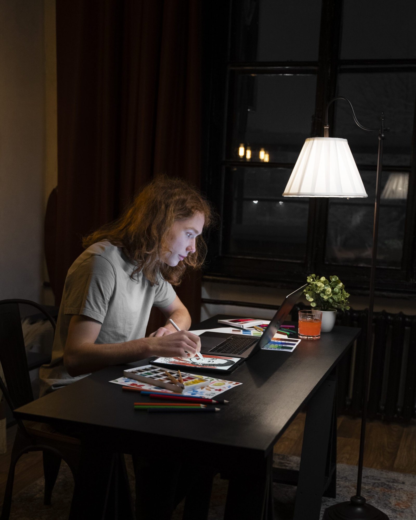 Creative website content writer working late on digital project with laptop and notes