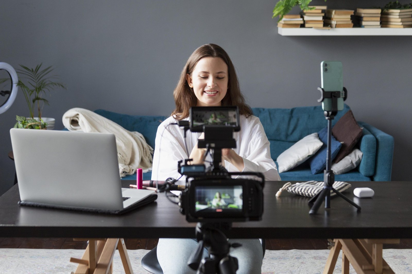 Female content creator recording beauty vlog at home studio with professional camera,